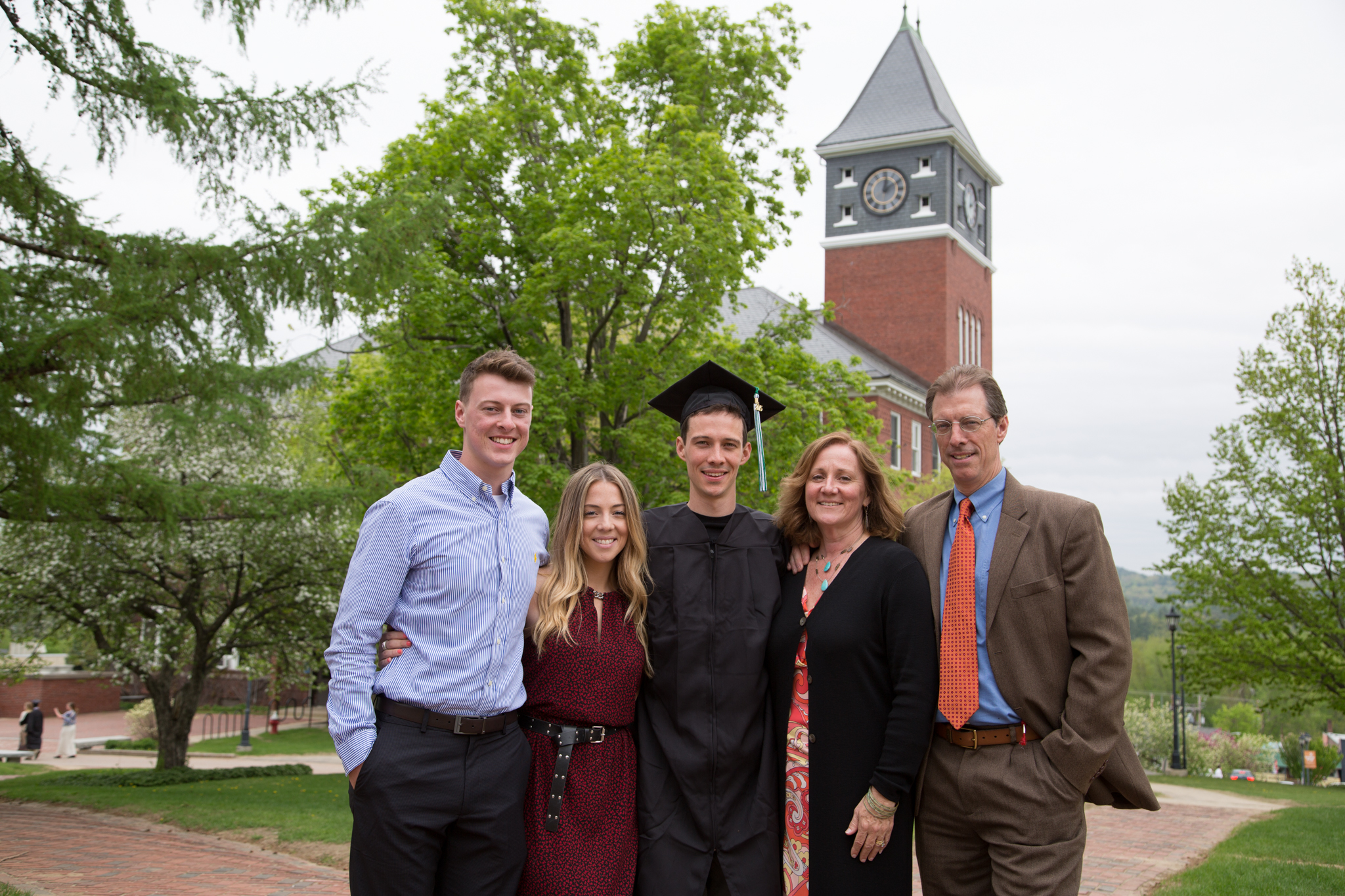 A jubilant graduate and his family pose in front of iconic Rounds Tower. Kaleb Hart ’11 photo.