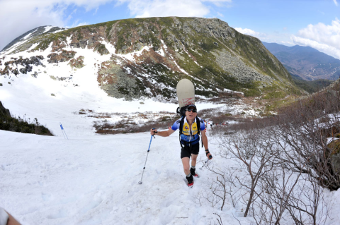 A snowboarder climbing snowy Mount Washington in 2012
