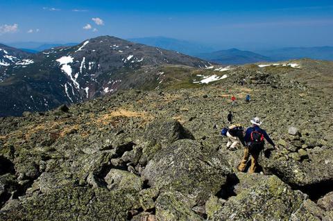 Hikers traversing rock piles