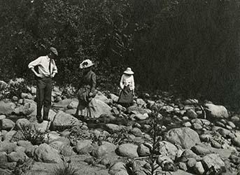 Mr. and Mrs. Mitchell—Mrs. Hamlin. Mrs. Mitchell has her skirt tied up and is tramping in her petticoat, 1911.