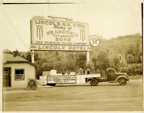 Photograph of sign outside Lincoln with the text: "Lincoln, N.H. 1/2 Mile Home of Franconia 100% American Bond The Parker Young Company Lincoln Hotel Hiltz's Station