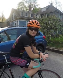 Mac Bevier on her bike in front of house