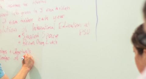 Student writing on a whiteboard