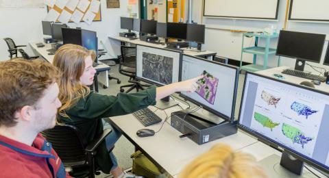 Students working on computers with geographic information systems.
