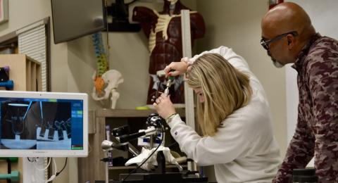 Student and professor working with a medical device.
