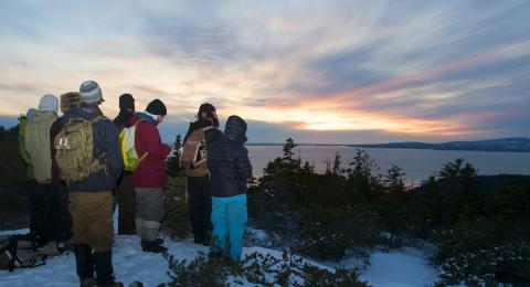 Students and faculty watch the sunset.