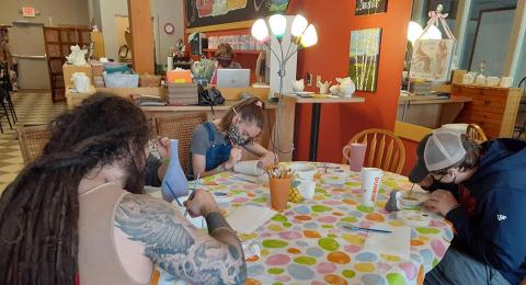 Students drawing at a table