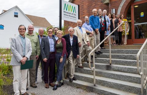 People posing for a photo outside of the Museum of the White Mountains
