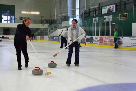 Students curling at ice arena