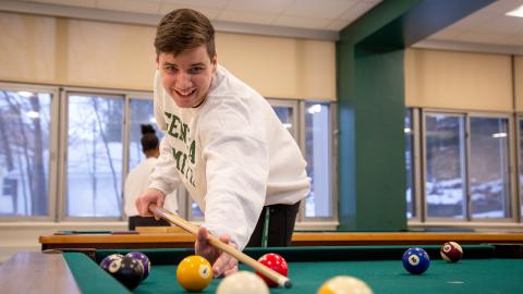 Community living student playing pool