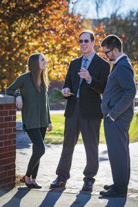 Donald Brix talking to faculty outside