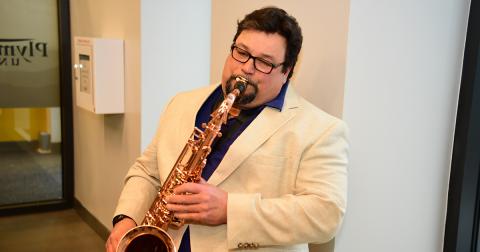 Mark Flynn playing the saxophone at event