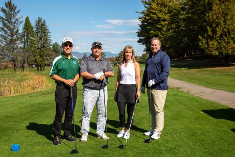 Barbara Dearborn ’60 Golf Classic people posing with golf clubs