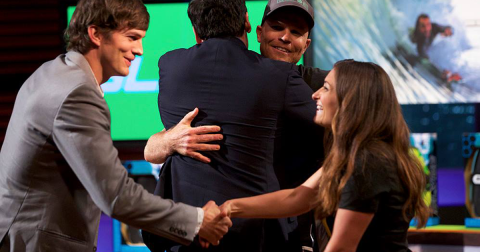 Angela Watts shaking hands with Ashton Kutcher