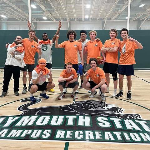 A group of students pose for a photo at a Campus Recreation basketball event.