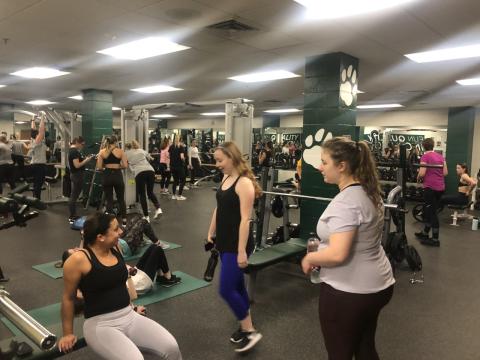 Students lifting weights during the Ladies Power Hour