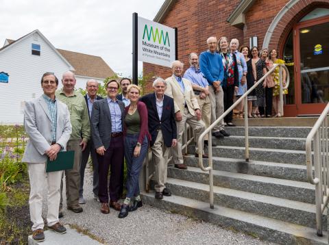 People posing for a photo outside of the Museum of the White Mountains