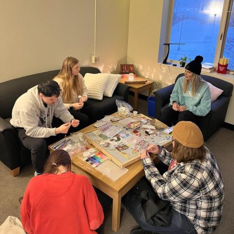 Students conversing while sitting on a sofa.