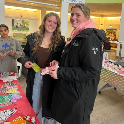 Students pose for a photo, smiling.