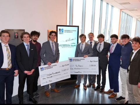 PSU Sales Institute group photo holding two checks