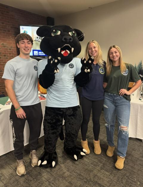 Students posing with panther mascot.
