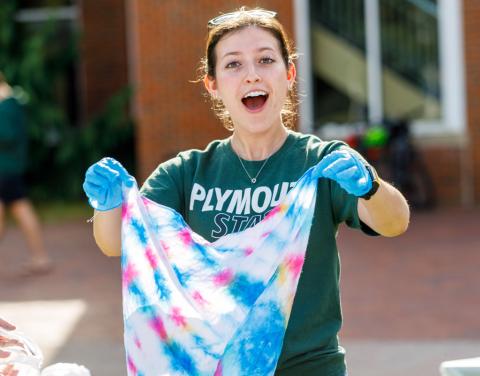 Student holding up tie dyed item