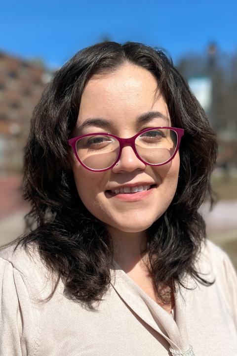 Woman smiling at camera, Sarai Santiago
