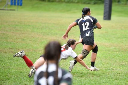 Marauders #12 dodging a tackle from a Keene State player.