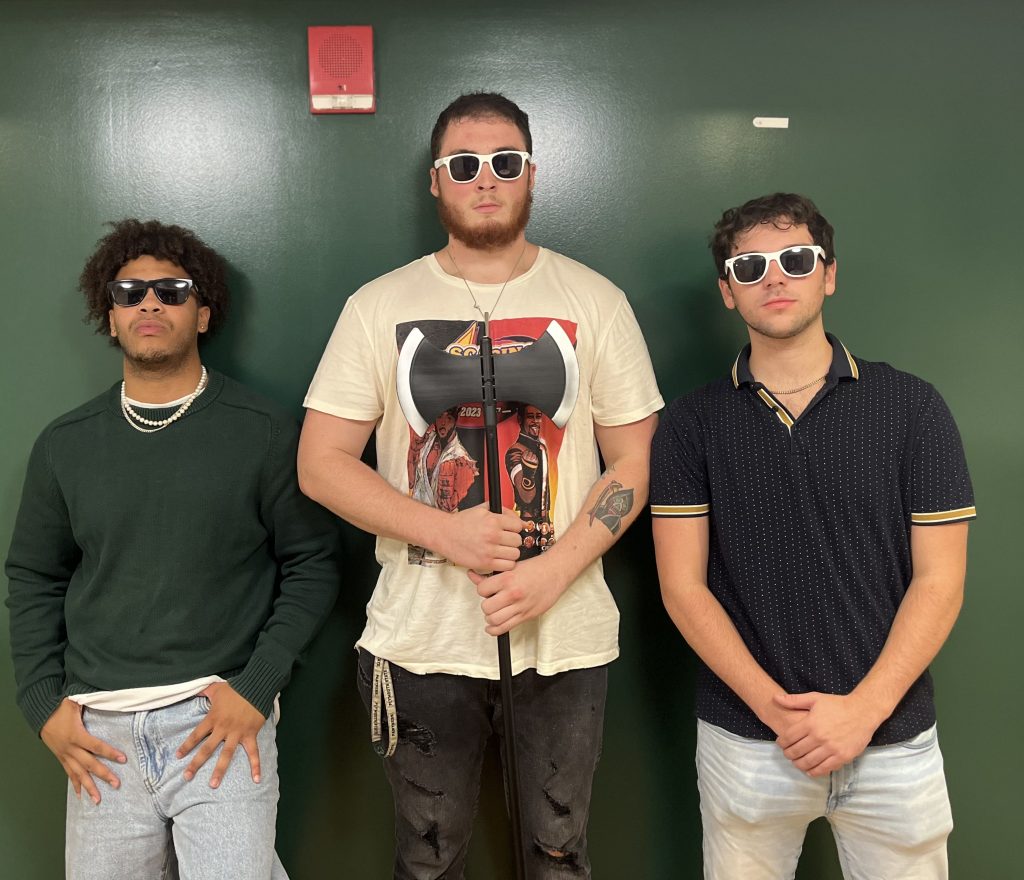 Three Boy Sluts in matching sunglasses. One is holding a battle axe